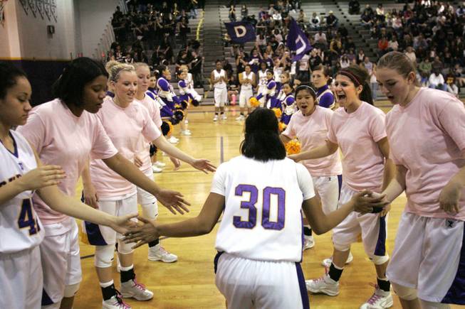 Players on both teams wore pink warmup shirts.