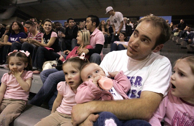 Mark Jimenez, with daughters, from left, Emily, 3, Emma, 3, Amy, 8 months, and Hannah, 4, get in the spirit.