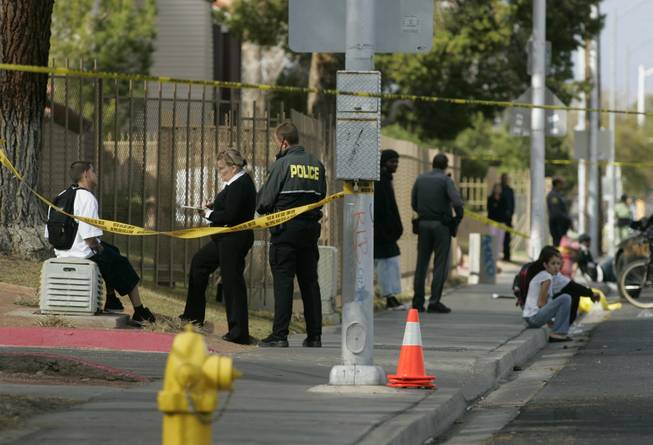 Law enforcement officers talk with teens at the scene of a shooting on Torrey Pines Drive near Bonanza High School Thursday, Feb. 21, 2008.