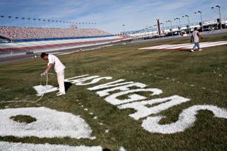 In preparation for a weekend full of racing, and the NASCAR UAW-Dodge 400 on Sunday, painters with Sport Designs painting company of St. George, Utah, Carlos Garcia, left, and James France, work on the infield logos at the Las Vegas Motor Speedway on Wednesday afternoon, February 27, 2008.
