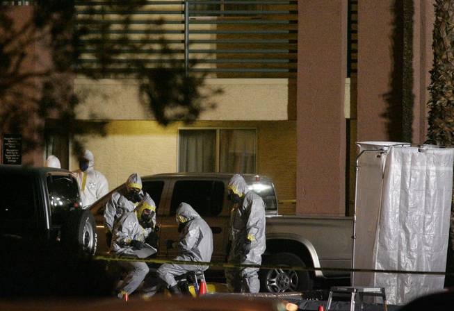 A hazardous materials crew confers outside the Extended StayAmerica on 4270
South Valley View Boulevard after a suspicious substance was found Thursday,
Feb. 28, 2008. Presumptive tests showed the substance to be ricin, Metro
police said. Ricin is a toxin that can be made from castor beans.