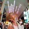 Tourist Melony McCarrell of Victoria, Texas, watches a public art demonstration on the Fremont Street canopy of a work by artist Jenny Holzer, “For Las Vegas.” Holzer’s piece for CityCenter features phrases scrolled on a giant LED screen.