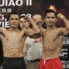 WBC super featherweight champion Juan Manuel Marquez, left, of Mexico and Manny Pacquiao of the Philippines flex during their weigh-in Friday at the Mandalay Bay Events Center. Pacquiao says their bout will be his last in this division. 