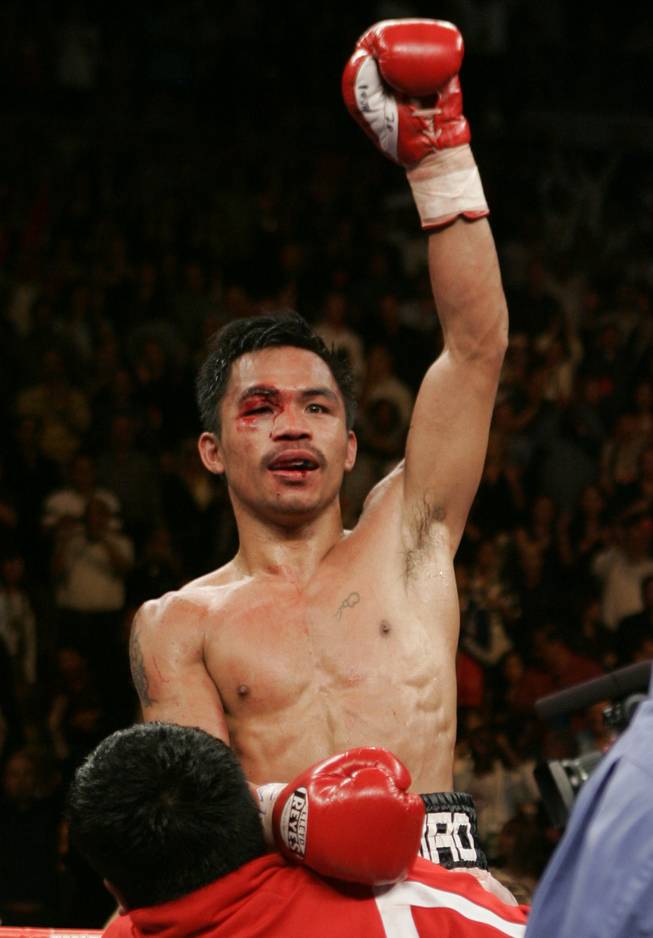 Manny Pacquiao celebrates after going 12 rounds with WBC super featherweight champion Juan Manuel Marquez in 2008.