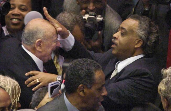 In this file photo of Monday, March 17, 2008, before a swearing in for ceremony for New York Gov. David Paterson at the Capitol in Albany, the Rev. Al Sharpton, right,  touches the brow of former New York Mayor Ed Koch, who once battled Sharpton but now calls him a friend and a "bona fide leader."  Of New York City's most prominent civil rights leader, Koch says,  "He used to be a demagogue. I don't think he is anymore".