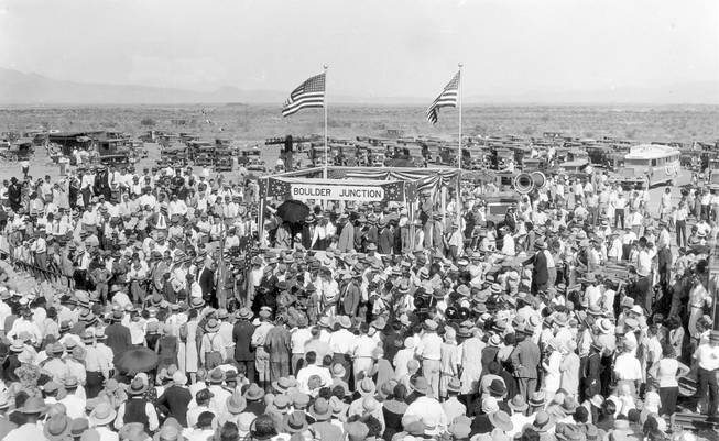 A large crowd celebrates the completion of the railroad at ...