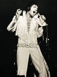 Elvis Presley wails into the microphone during a 1970 performance at the International Hotel. 