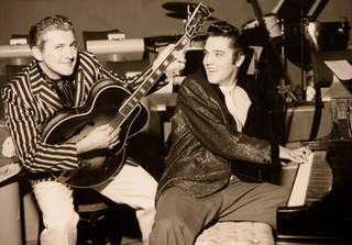 Liberace and Elvis Presley trade jackets and instruments in an impromptu jam session at the Riviera on Nov. 14, 1956.