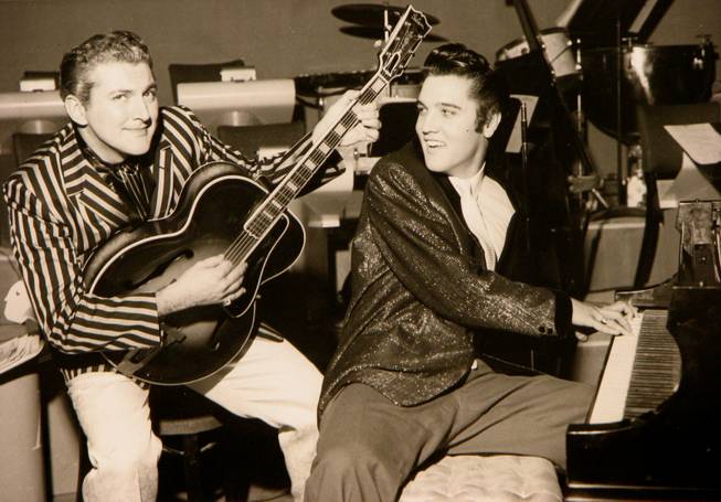 Liberace and Elvis Presley trade jackets and instruments in an ...