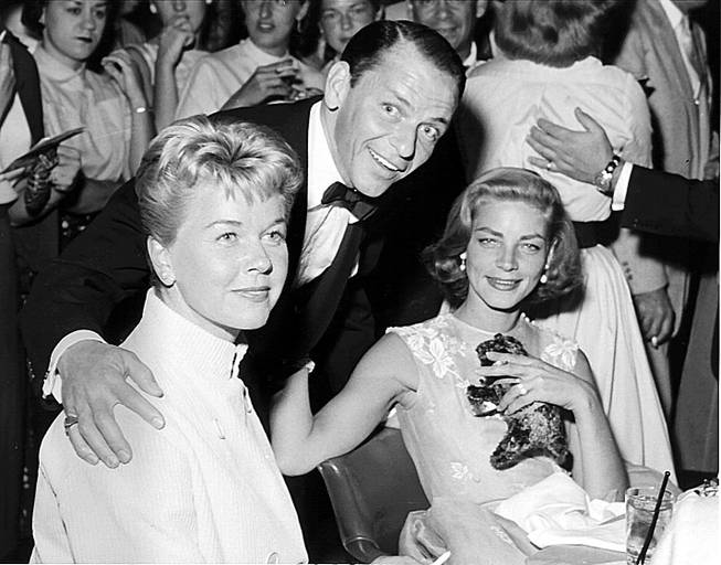 Doris Day, left, Frank Sinatra and Lauren Bacall attend a show at the Sands hotel-casino on Sept. 15, 1966. Bacall and Sinatra were involved in a relationship after the death of Bacall's ex-husband Humphrey Bogart. Sinatra proposed to Bacall but he cut the romance short after the media made the engagement public.