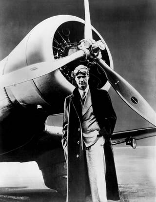 Howard Hughes poses in front of the his record setting Northrop Gamma Monoplane in this 1930s photo. Hughes broke his first aviation record in the Gamma when he made the west-east American transcontinental run in 9 hours, 26 minutes, and 10 seconds.
