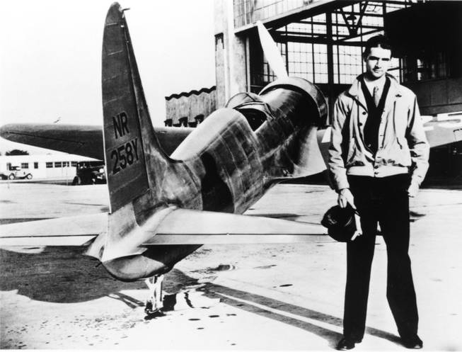 A young Howard Hughes stands next to his H-1 racer airplane in this 1930's photo. The H-1 was the first aircraft produced by Hughes Aircraft Corporation and Hughes would set the world airspeed record and break his own American transcontinental speed record in the H-1.