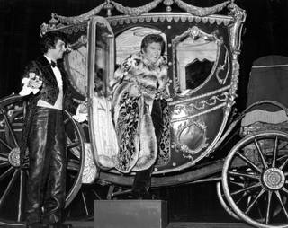 Liberace arrives at one of his shows at the Las Vegas Hilton, in an extravagant horse-drawn carriage. The singer's lavish costumes and stage props were funded by his $125,000 weekly salary.