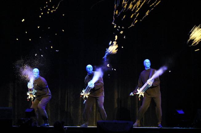 Members of Blue Man Group shoot paper into the audience at the sold-out "Las Vegas Salutes the Spirit of America" show benefiting the USO at Mandalay Bay Events Center on Sunday, Nov. 11, 2001.