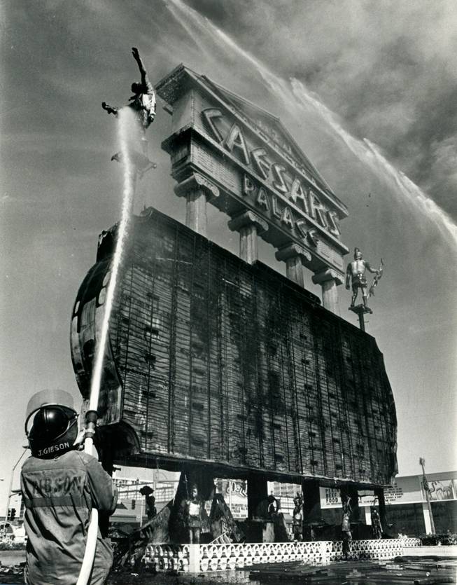 Clark County firefighters extinguish the last flickers of flame that engulfed the Caesars Palace marquee, March 27, 1980. The blaze erupted shortly after 12:30p.m. and caused $200,000 worth of damage. The 70-foot fluorescent sign was ignited by an electrical short as workmen were changing the headliner from Paul Anka to Tom Jones. Jones was the headliner two years earlier, when another small fire engulfed the sign. 
