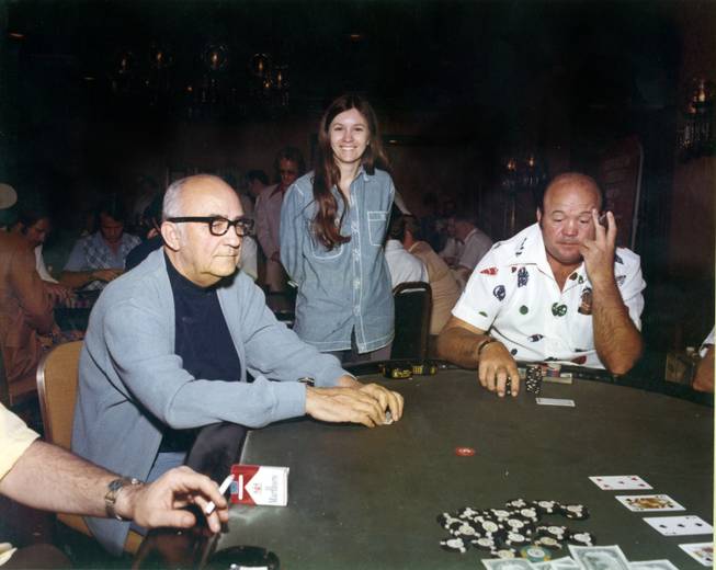 In this 1974 photo, left, Johnny Moss, Becky Binion and Puggy Pearson partake of some of the action at the  World Series of Poker at Binion's Horshoe casino downtown Fremont Street in Las Vegas.