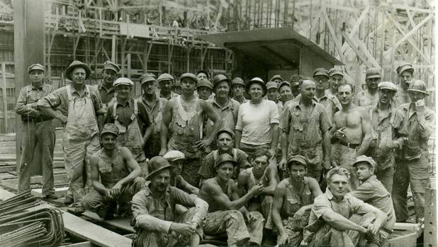 The man in the middle of the photograph, known as "Boss Doc,'' is superintendent of a crew at Hoover Dam. This crew built the center section of the power house, machine shops, seismograph room, clock room and battery room in the summer of 1935.