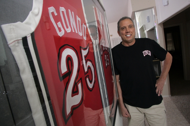 Glen Gondrezick poses with his jerseys in his home last month. As he sped toward the operating room, Gondo was pulled over several times.
