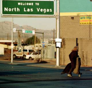 A homeless man crosses Las Vegas Boulevard into North Las Vegas on Feb. 15, 1999, showing that it's not all glitz and glamour in “Sin City.”