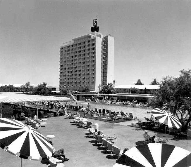 The Sahara's 14-story tower rises out of the desert as guests lounge around the pool in this 1960s photo. Real estate developer Del Webb bought the property from Milton Prell in 1961 and orchestrated a $100 million merger between his construction company and the California-Sahara Corp., creating the first publicly traded company to own casinos.