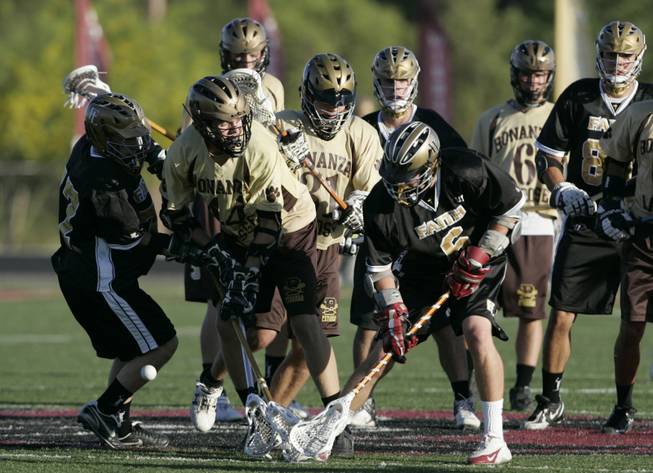 Bonanza and Faith Lutheran players battle for the ball during the state high school lacrosse championship game Saturday at Faith Lutheran. Bonanza won the men's and women's varsity titles.