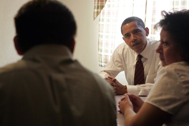 Democratic presidential candidate Senator Barack Obama talks with Francisco Cano, left, and his wife Felicitas Rosel at their home in North Las Vegas. The casino workers told Sen. Obama they are afraid of losing their home to foreclosure.