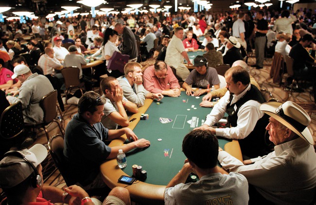 Poker legend and 10-time World Series of Poker Champion Doyle Brunson, right, in hat, competes at the Rio on Friday.