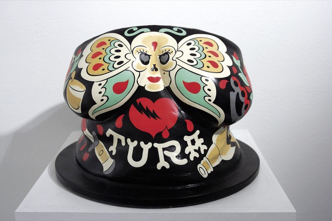 The bust of Tura Satana was painted by Mitch O'Connell, a Chicago tattoo artist and self-described fan of the burlesque performer. 