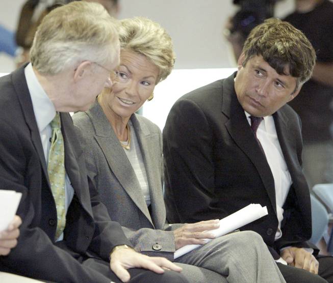 When Pat Mulroy, center, got involved in the land act, she demanded that it contain a clause diverting 10 percent from land sales to her Southern Nevada Water Authority. Mulroy is seen with Reid, left, and Interior official Bennett Raley in 2004.