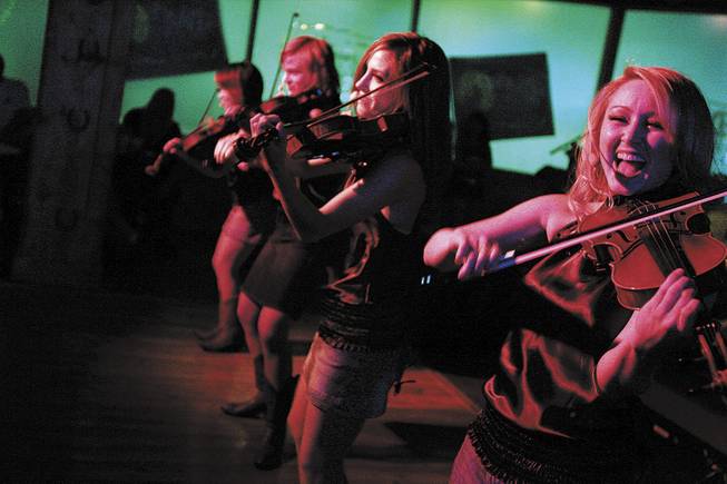 New Country Strings members, from right, Kristina Bauch and Alicia Enstrom play with their fiddling partners at Dixie's, which opened Memorial Day weekend.