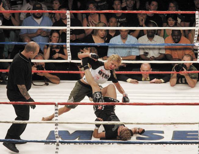 Kim Rose blocks Kim Couture with her legs during "A Night of Combat," a mixed fight card of boxing and mixed martial arts. Rose won by decision. 