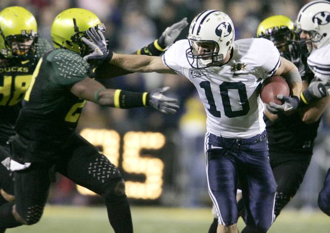 BYU's Matt Allen tries to cover up the embarrassing color scheme sported by Oregon's J.D. Nelson during the Las Vegas Bowl in 2006.