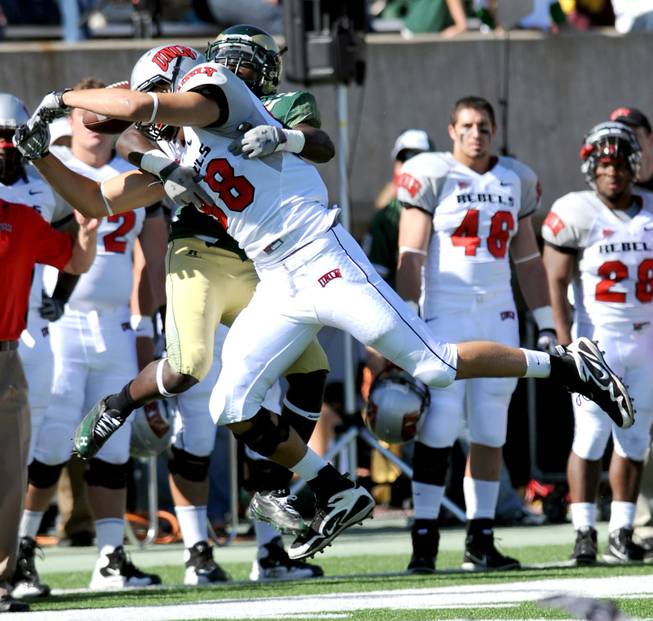 UNLV tight end Anthony Vidal (88) attempts to catch a pass as Colorado State running back Leonard Mason (2) grabs him in coverage during Saturday's game at Hughes Stadium in Fort Collins, Colo.