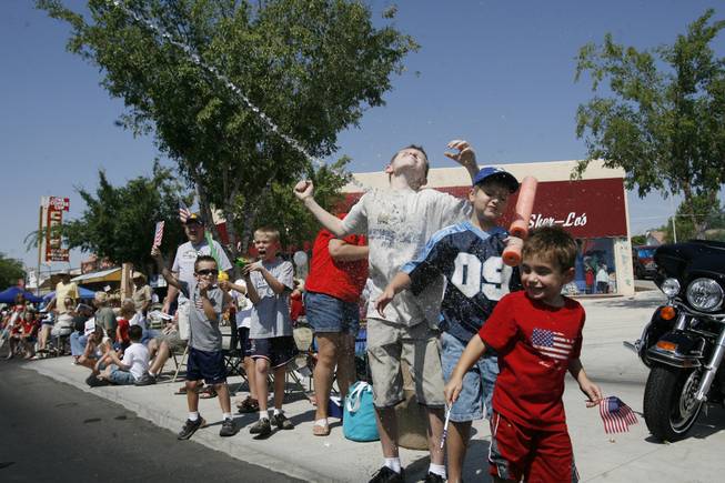 Young spectators are sprayed with water during the 60th annual Damboree parade, Boulder City's Fourth of July celebration.