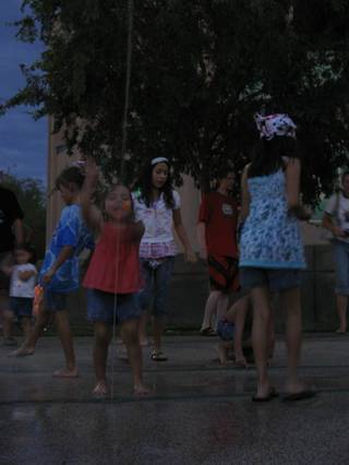 A young girl plays in the water at the Henderson Events Plaza and Convention Center before the annual Fourth of July fireworks.