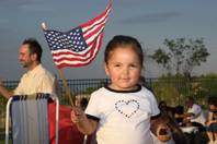 While enjoying a summertime picnic, 2-year-old Julia Gomez waves her American flag during the Las Vegas Philharmonic's 10th Anniversary Star Spangled Spectacular Fourth of July celebration at Hills Park in Summerlin.