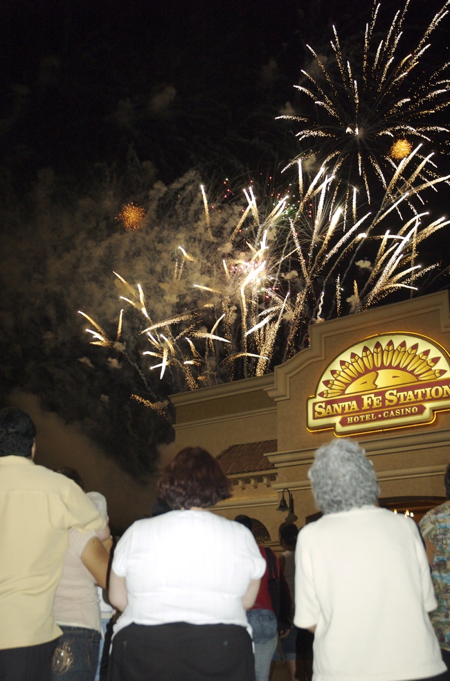 Hundreds of locals and tourists stood in the parking lot and garage at the Sante Fe Hotel/Casino and watched fireworks explode overhead.