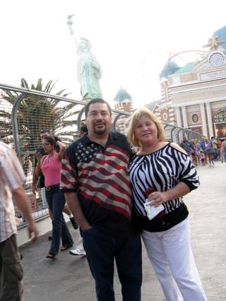Roger and Maribel Solorzano smile in front of New York's Statue of Liberty. The Solorzanos are from Palm Springs, Calif.