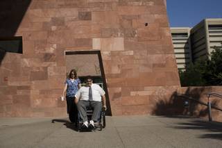 Kathy, left, and Tom Urbanski arrive at the Regional Justice Center for Tom to testify in a grand jury investigation into the 2007 Minxx strip club shooting that left him paralyzed from the waist down. 