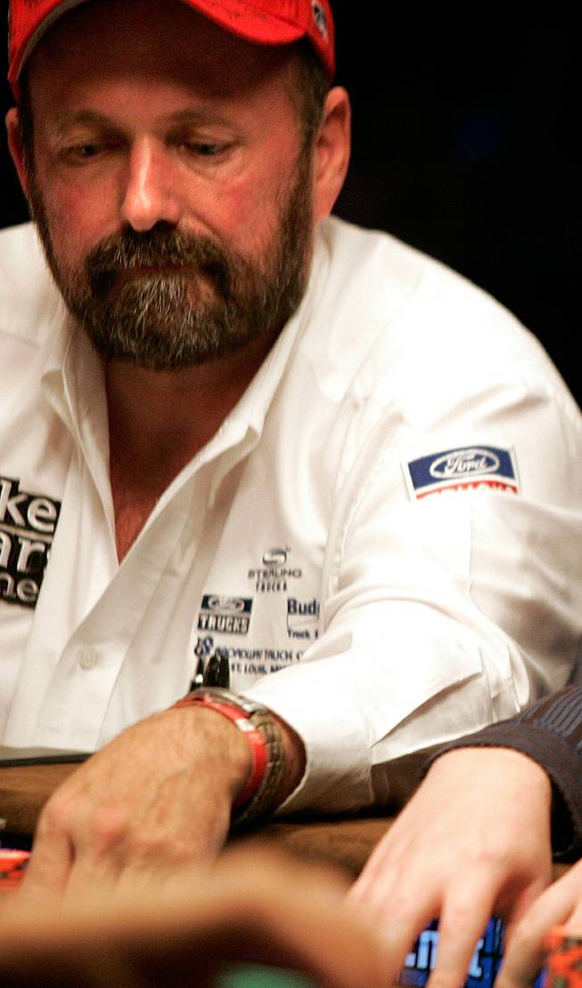 Dennis Phillips of Cottage Hills, Ill., mulls a hand Monday. Phillips has the lead among the final nine players and will resume play with 26,295,000 chips on Nov. 9.