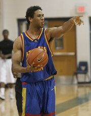 Xavier Henry, ranked by Rivals.com as the top shooting guard prospect in the 2009 class, directs traffic Tuesday evening at the National Youth Basketball Championships. Henry is considering Memphis, Kansas, Texas and UCLA.