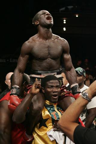 Joshua Clottey celebrates his IBF welterweight title victory over Zab Judah Saturday night at the Palms Casino in Las Vegas. Clottey won by unanimous decision in the ninth round when Judah could no longer fight because of a large cut over his right eye.