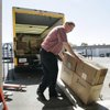 Dean Warner loads boxes into his warehouse at Moving Box Rentals that were left over from Steve Saltzman closing his business for a move to Los Angeles last week.  