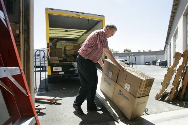Dean Warner loads boxes into his warehouse at Moving Box Rentals that were left over from Steve Saltzman closing his business for a move to Los Angeles last week.  