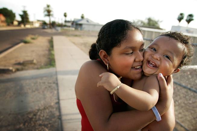 "He's always smiling at people. Even with strangers," said big sister Gabriella Ramirez, 10, when I commented that her little brother, Jovany, was probably the most smiley and cute 1-year-old I had ever seen. Jovany loved to smile, and then when I got too close, loved to bat at my camera lens. I met them while videographer Matt Toplikar and I were cruising through one of the Hispanic neighborhoods in town, talking to people about the election. <em> - Leila Navidi</em>. 