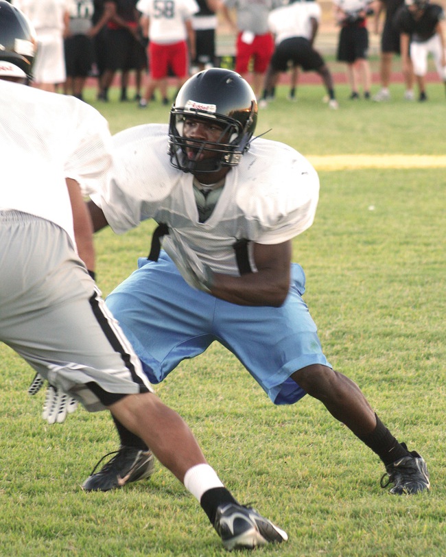 Las Vegas High running back Reggie Bullock, who also plays in the secondary for the Wildcats, takes part in a defensive drill during the first day of full contact practice at LVHS. Bullock, a senior, rushed for 12 scores last season at Western.