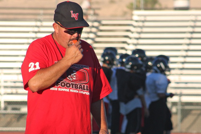 Las Vegas High football coach Chris Faircloth takes control of a hitting drill during the first day of full contact practice Monday at Frank Nails Field.
