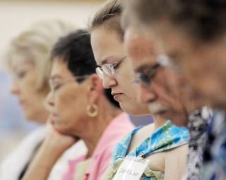 Janet Boyer, center, is silent in prayer with other members of the United Methodist Church during a service inside the Boulder City Senior Center. The church is moving ahead with plans to build a sanctuary.