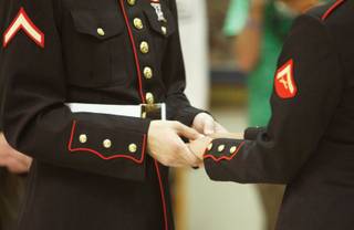 Mathew Fleek, 24, and Monique Moses, 23, both Marines stationed at Twentypalms, Calif., exchange their vows.
