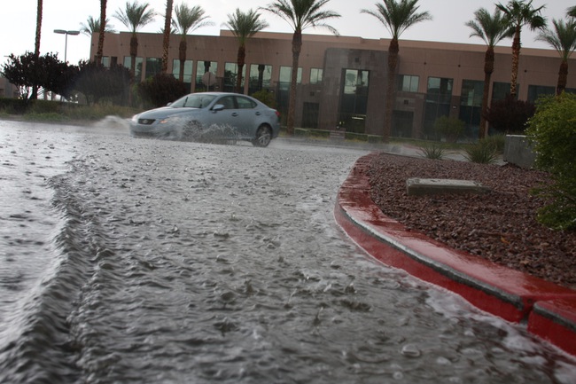 A thunderstorm that rumbled through Henderson brought flooding to streets and parking lots, including this area along Corporate Drive just west of Green Valley Drive. 
